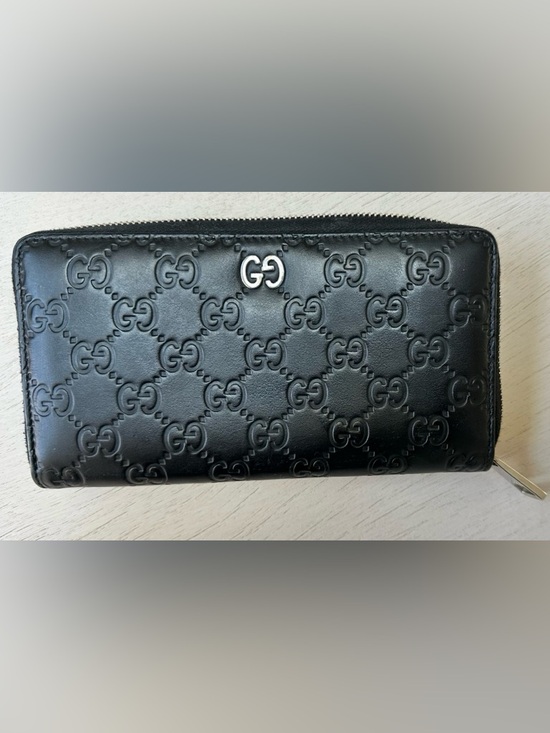 Gucci Handbags - Authentic Gucci GG embossed zip-around wallet in black leather. Made in Italy.